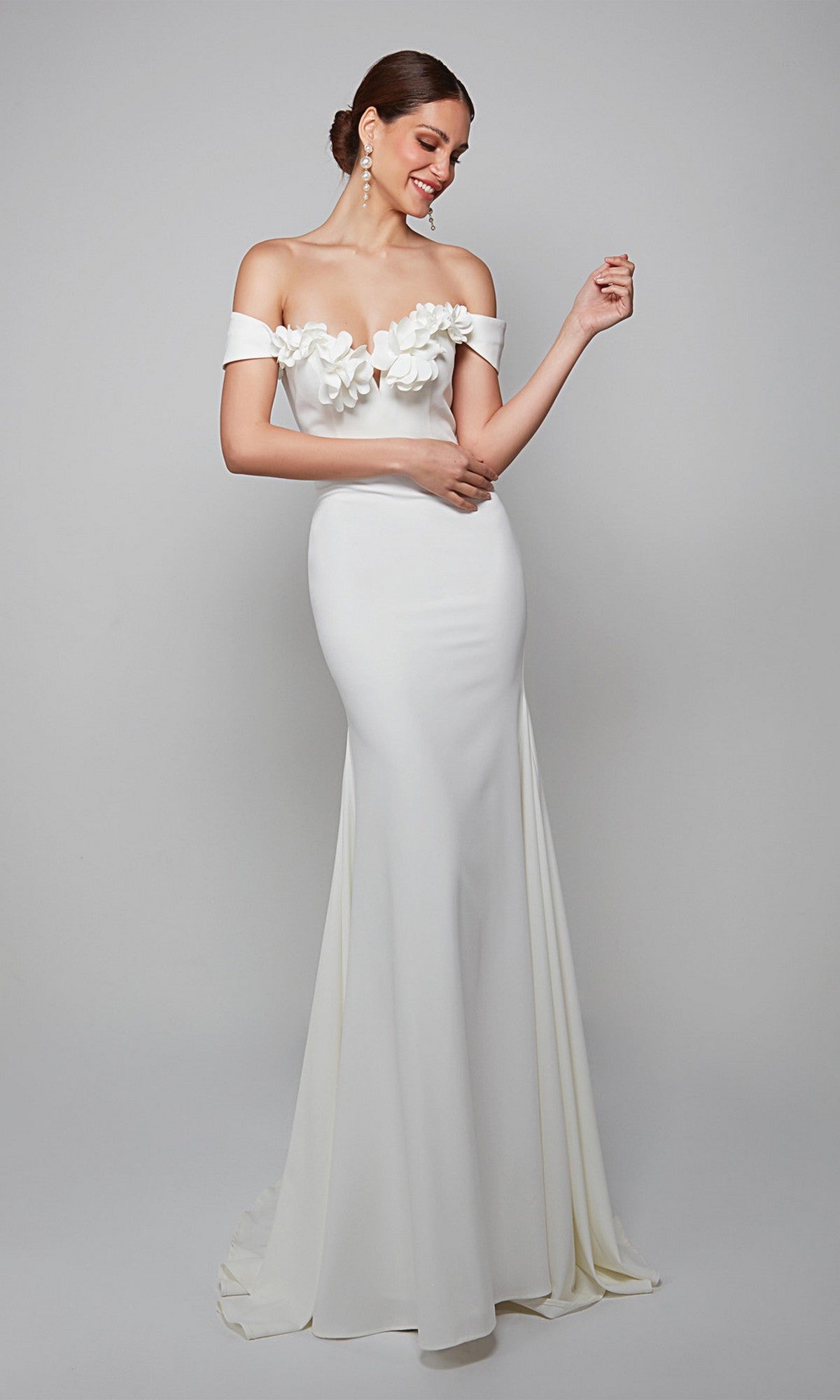 A woman wears the Alyce 7062 long formal dress with 3D floral bodice accents, posing against a plain background—an elegant choice for evening events.